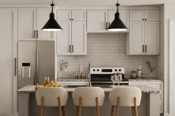 A kitchen with white cabinets and a marble countertop.